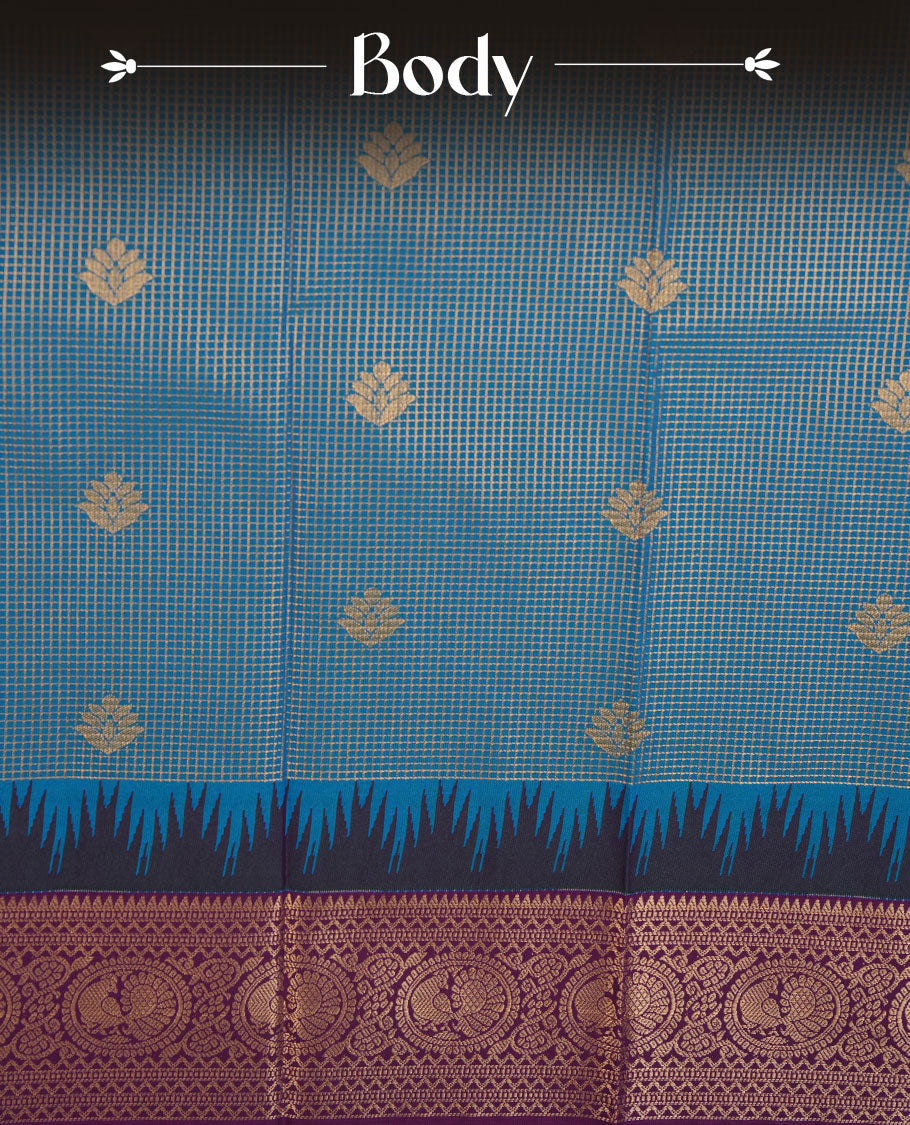 Teal colour semi silk saree highlighting gold zari check pattern  and motifs across body, featuring contrast purple colour border with gold zari pattern, comes with matching blouse .