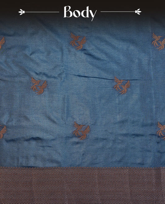 Teal colour semi banaras tussar silk saree highlighting gold zari bird motifs on body, complemented by self colour with antique zari border, paired with matching blouse piece.