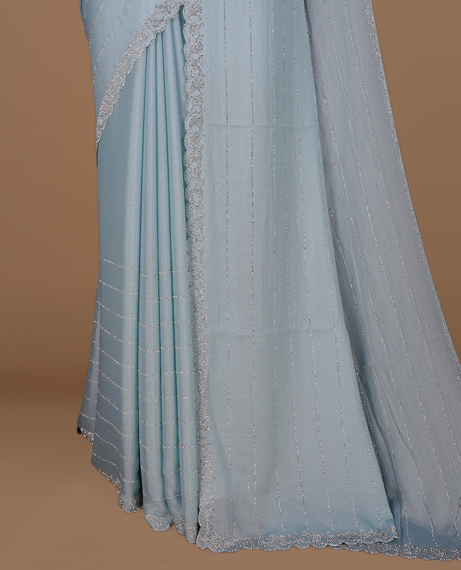 Mint colour designer saree featuring white stone stripes on body, highlighting white stone with scalp border, paired with matching blouse piece.