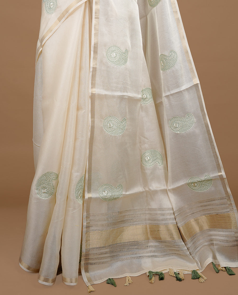 Cream colour Tussar saree featuring Light olive colour Mango pattern with chikankari embroidery work, highlighting gold zari simple border, paired with matching unstitched blouse.