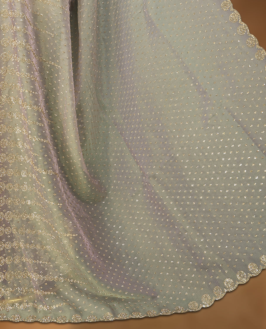 Gray and pink double shade Colour net shimmer fancy saree adorned with scattered white stone buttas all over the body, paired with a delicate stone worked border and matching blouse