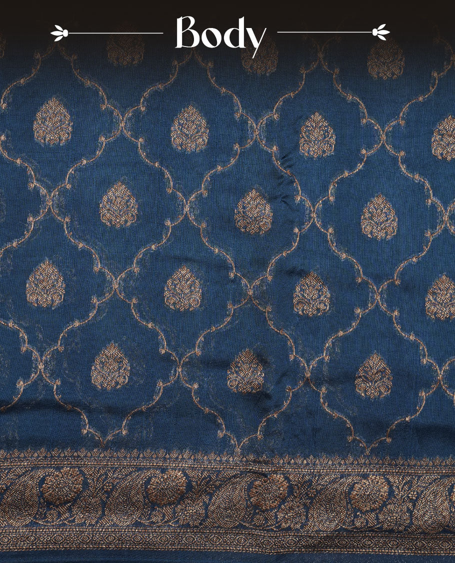 Crystal Teal colour semi Banaras saree with gold zari buta motifs, finished with a traditional gold zari border and pallu, paired with a matching blouse.