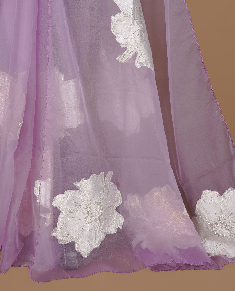 Lavender colour semi organza saree featuring white floral & gold thread pattern, highlighting scalp design border, paired with matching blouse piece.