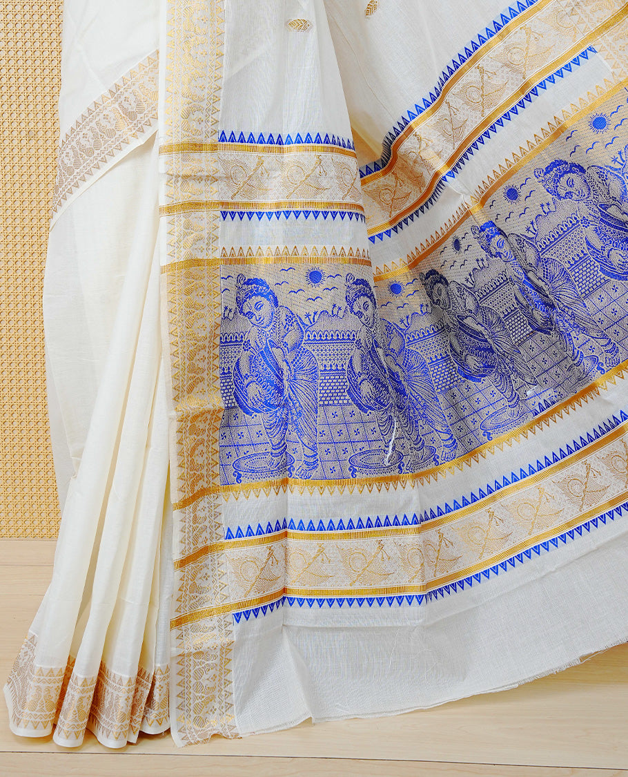 Cream Colour Cotton Kerala Saree Featuring Gold Buttas on the Body, a Classy Gold Zari Border, and a Traditional Blue Colour Lord Krishna Thread work and Gold Zari Pallu, Paired with a Matching Blouse Piece.