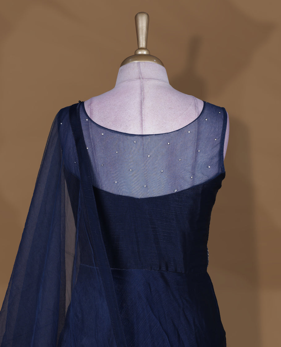Navy blue colour Gown with stitched sleeveless embellished blouse featuring sheer yoke and waist detailing, matching stitched flared lehenga with tassel accents, and plain sheer dupatta.