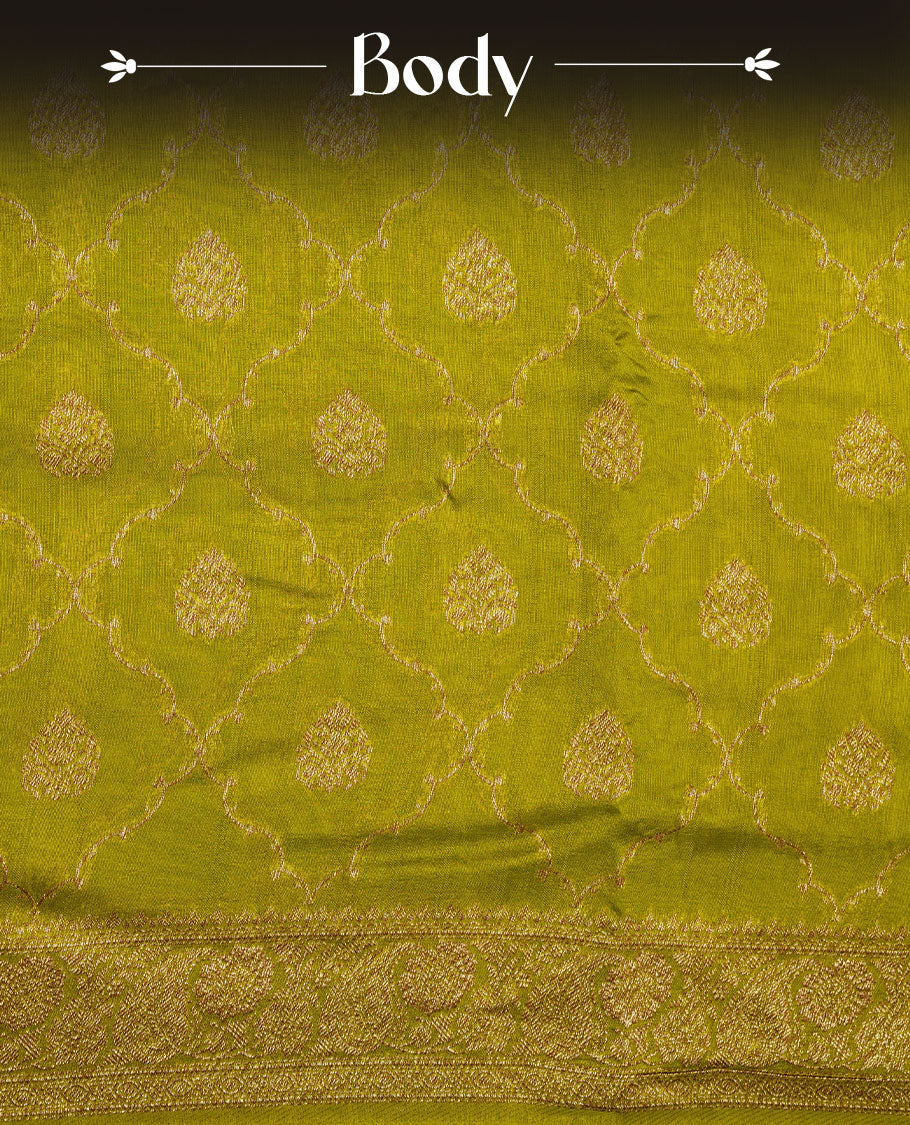 Olive colour semi Banaras saree with gold zari buta motifs, finished with a traditional gold zari border and pallu, paired with a matching blouse.