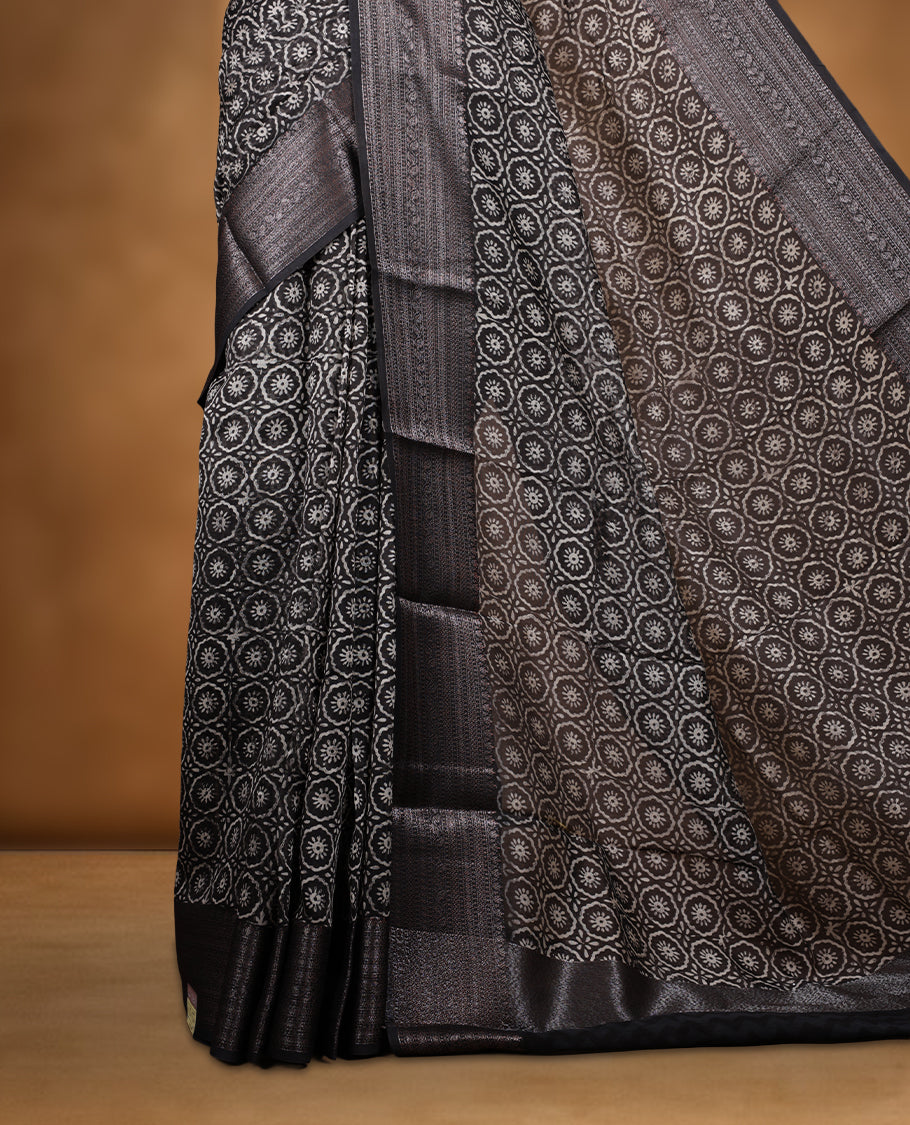 Black colour chanderi silk saree with Floral block print On body, compilmented by self colour border with antique zari pattern and a matching blouse.