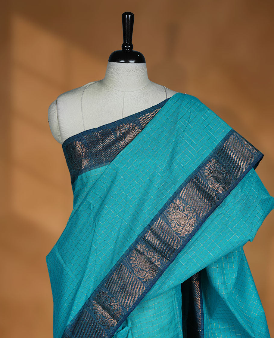 Aqua colour sungudi cotton saree featuring gold zari check pattern across body, contrast Teal colour with gold zari pattern on border, without blouse piece.