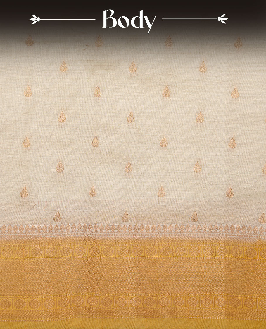 White gold colour semi tussar saree featuring Gold zari buttas body, contrast Yellow colour gold zari border and comes with matching blouse piece.