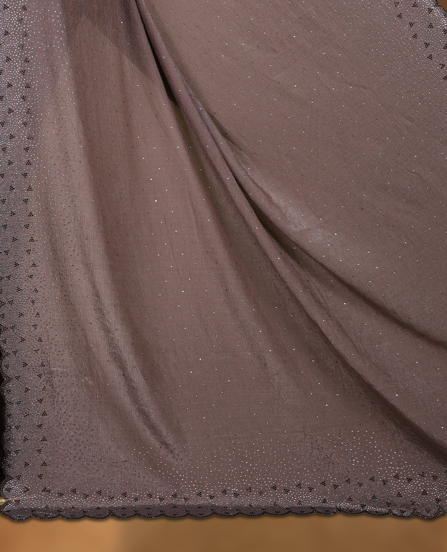Dusty brown colour chiffon designer saree, featuring black and white scattered stone on body, stone work and heavy stone pattern on border and  pallu, Paired with matching blouse.
