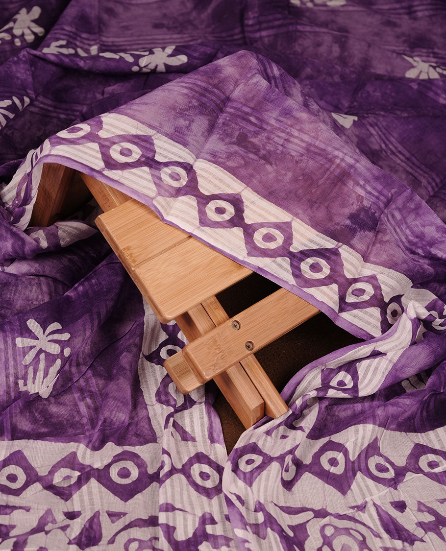 Purple colour churidar material featuring white floral printed body, paired with a matching chevron printed dupatta.