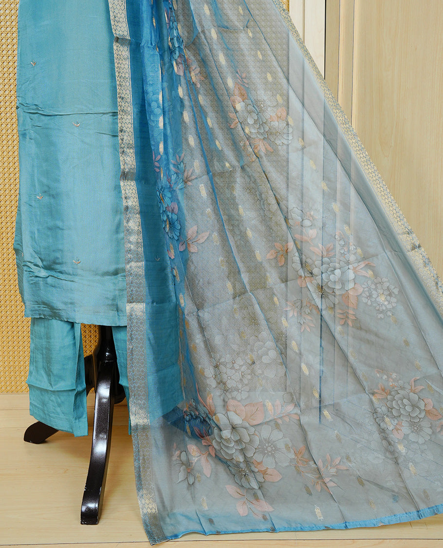 Sky Blue colour churidar set featuring delicate bead & stone Work on the V-neckline, paired with matching solid pants and a floral printed dupatta.