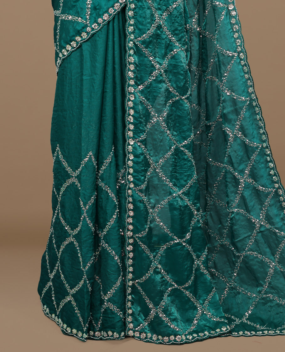 Teal colour designer saree featuring Sequins & cut beats worked body, cut beat worked border, paired with matching unstitched blouse.