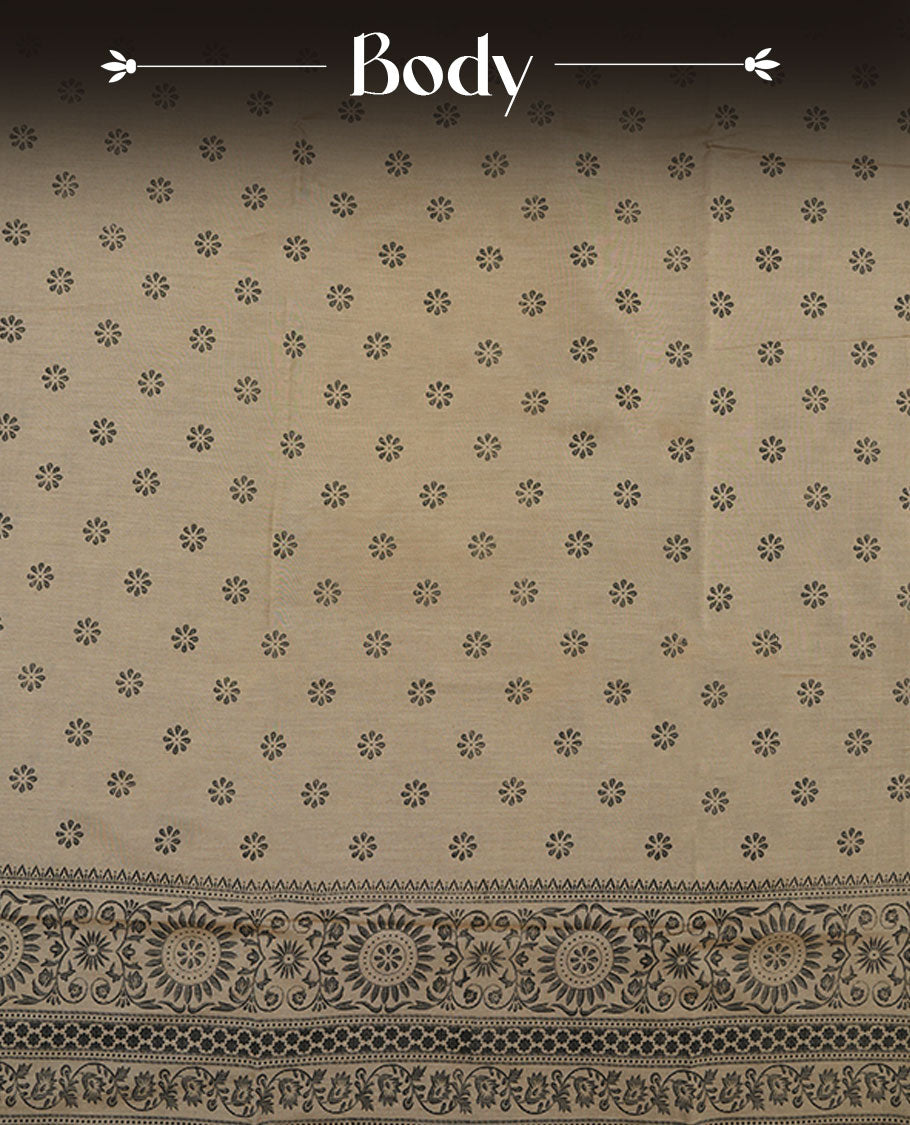 Dark Beige colour poly cotton saree with black floral butti motifs on the body, paired with a matching pallu featuring black ornate floral jaal and stripes on the border, and a coordinated all‑over black paisley printed blouse piece.