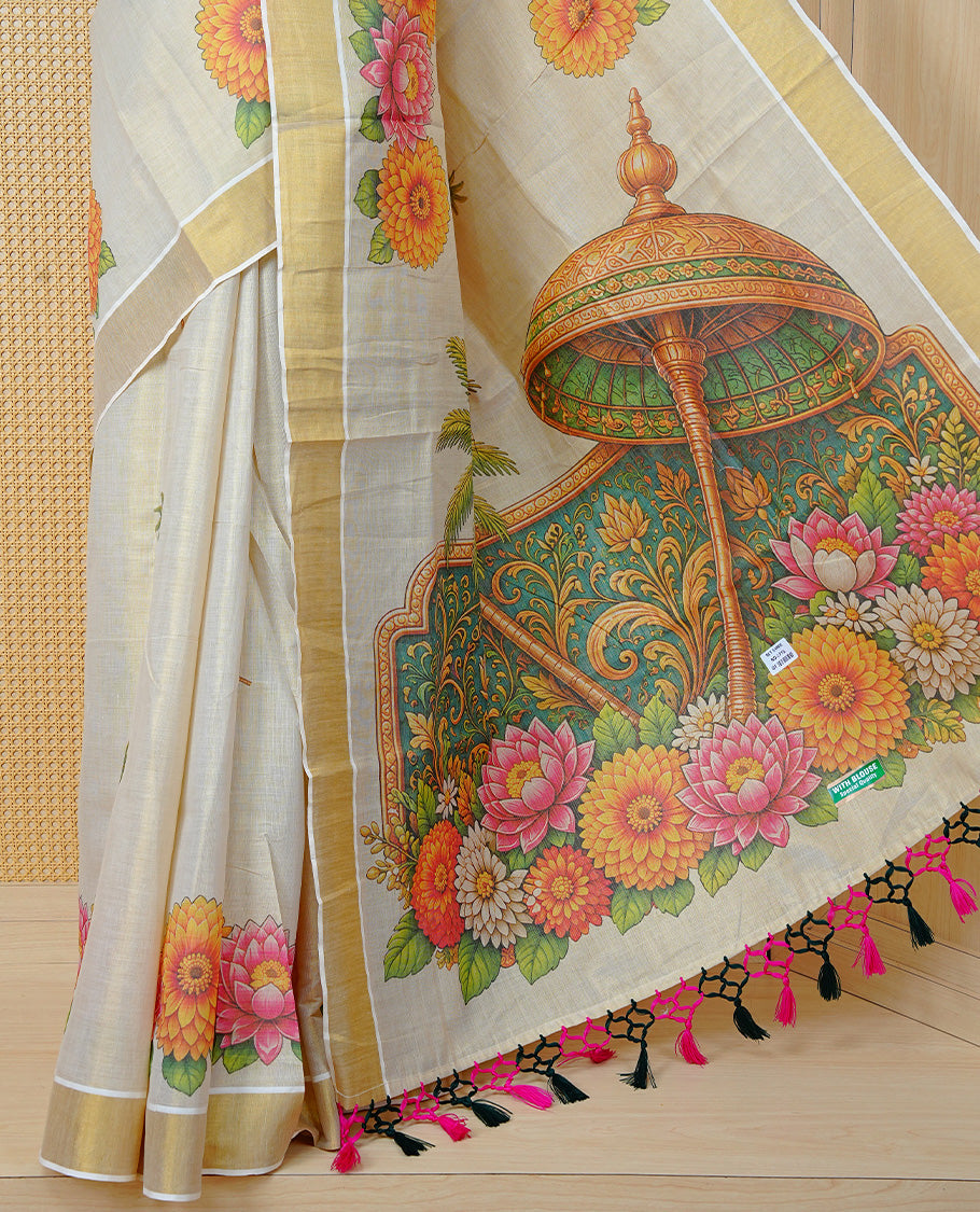 Cream Colour Tissue Kerala Saree Featuring Vibrant Digital Floral Prints & Onam Team Printed Pallu, Beautifully Enhanced With A Classic Gold Zari Border And Contrast Tassels. Paired With A Matching Blouse Piece.