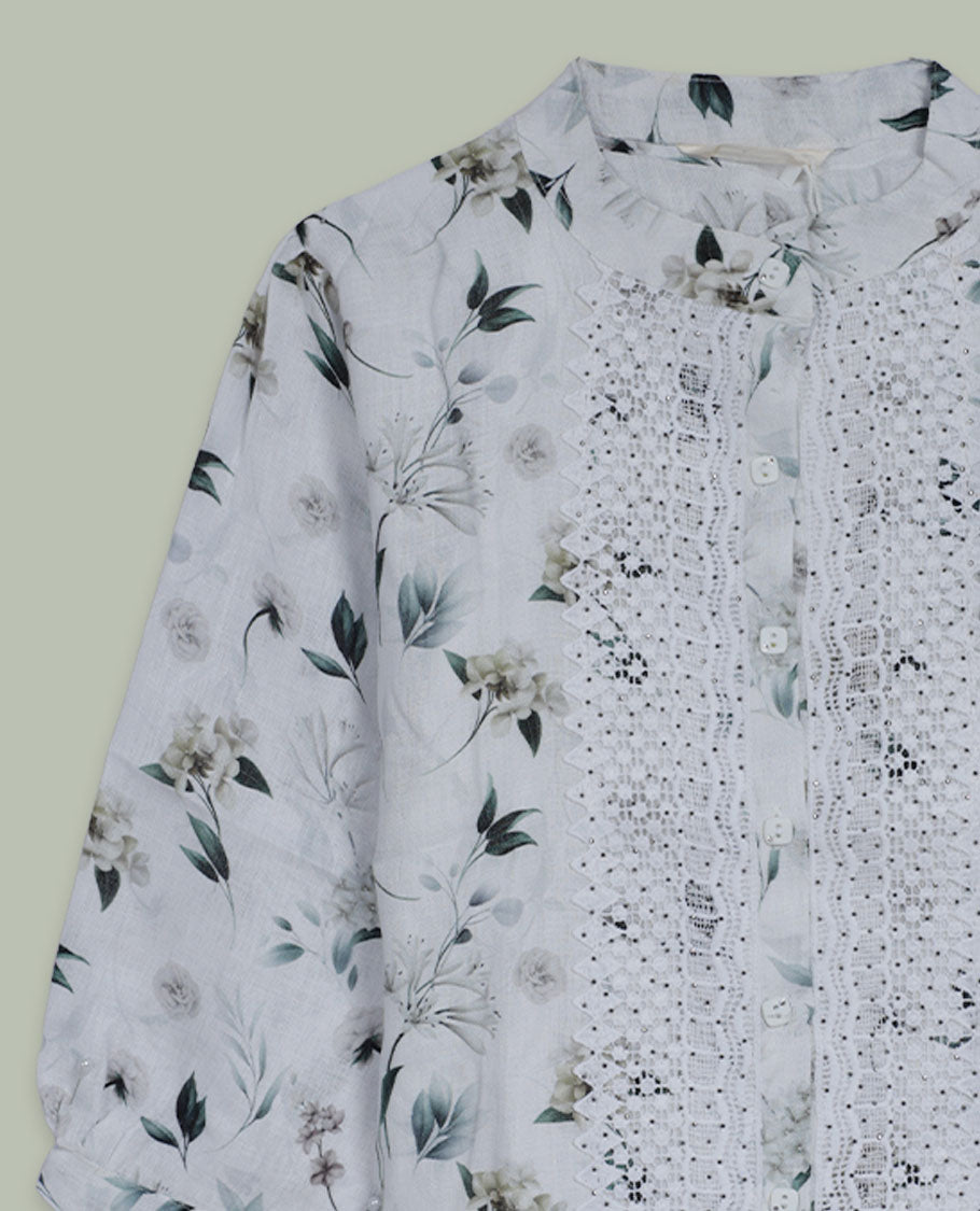 White floral printed shirt top with band collar, three-quarter sleeves, and front button placket framed by intricate lace and pintuck detailing.