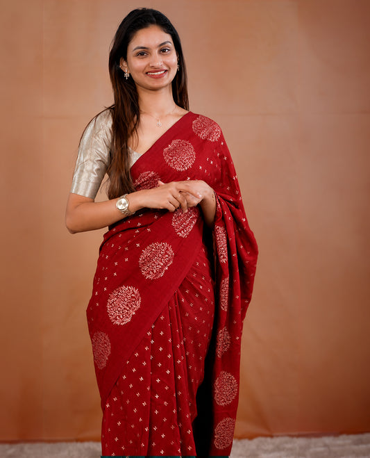 Red colour vijithra silk saree featuring small zari details on body, Tree design border.