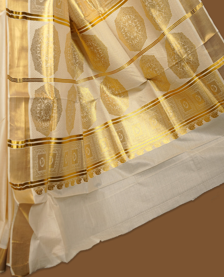 Elegant Off white colour cotton Kerala saree with gold zari buttas, broad kasavu border, and richly woven traditional pallu, paired with a matching blouse