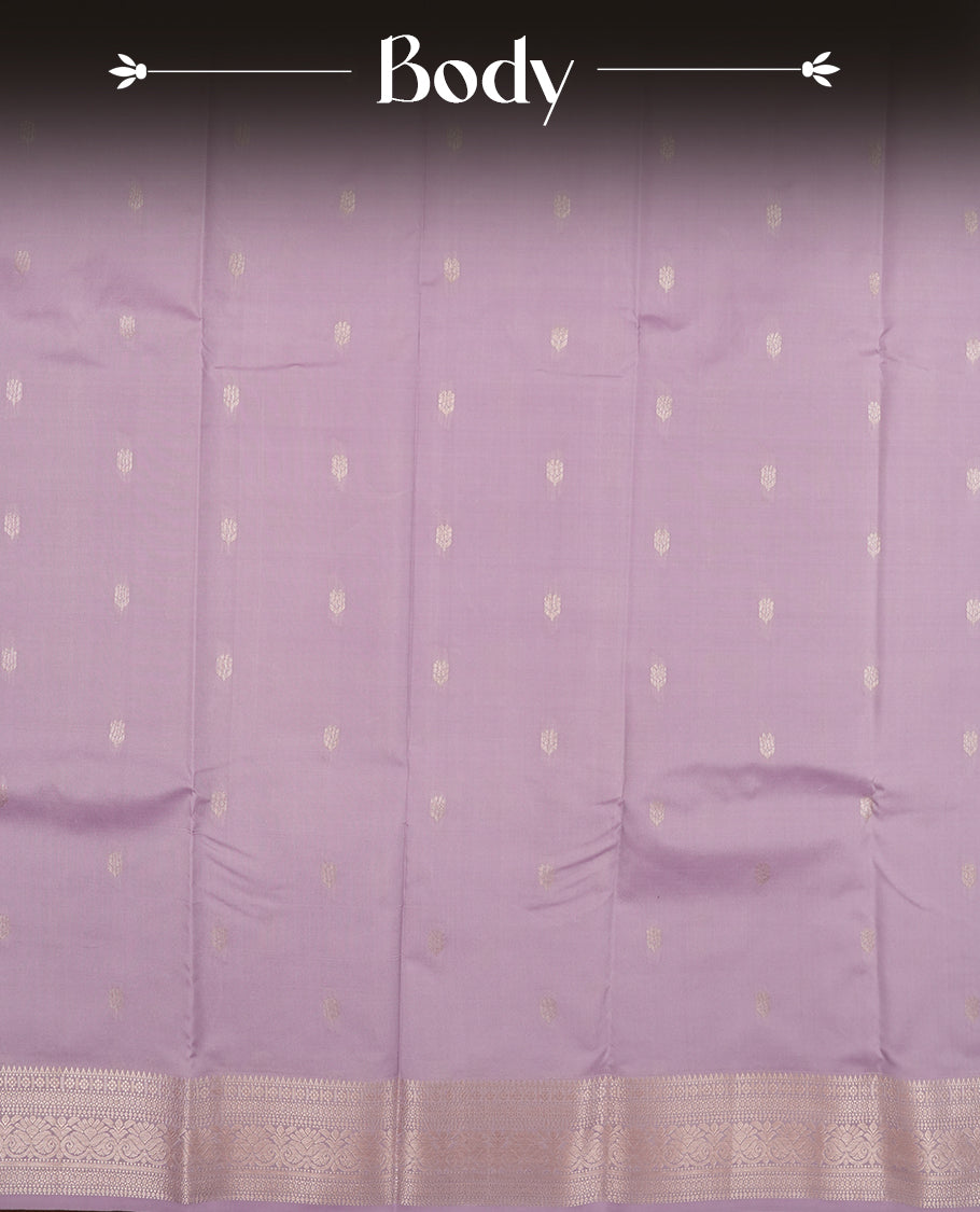 Lavender colour semi soft silk saree featuring a golden textured patterned body, complemented by self coloured golden traditional motifes on pallu & border and a matching blouse piece.