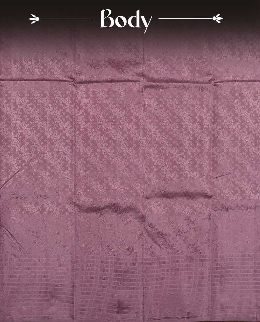 Medium grape colour semi soft silk saree featuring a self coloured textured patterned body, complemented by self coloured Square motifs on pallu & border and a matching blouse piece.