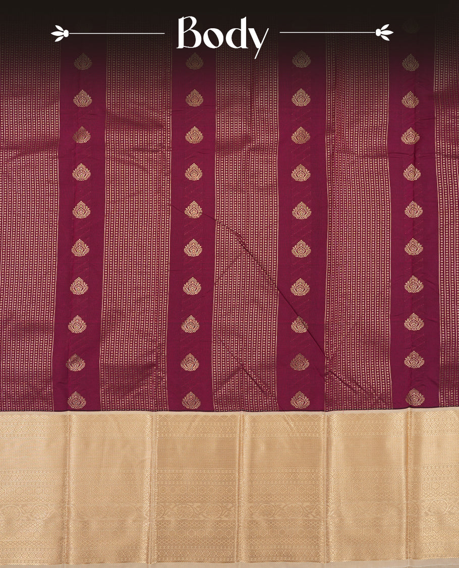 Burgundy colour Semi Silk Saree with gold zari striped patterns on the body, paired with a contrasting cream colour traditional pallu and border, and a matching blouse piece.