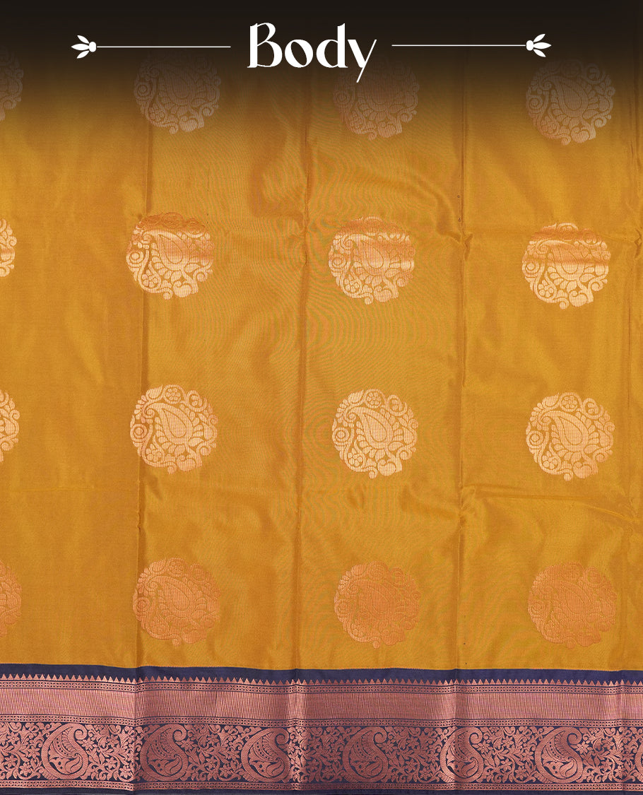Dark mustard colour Semi Silk Saree with copper zari motifs on the body, paired with a contrast Dark blue colour pallu with copper zari traditioal border, and a matching blouse piece.