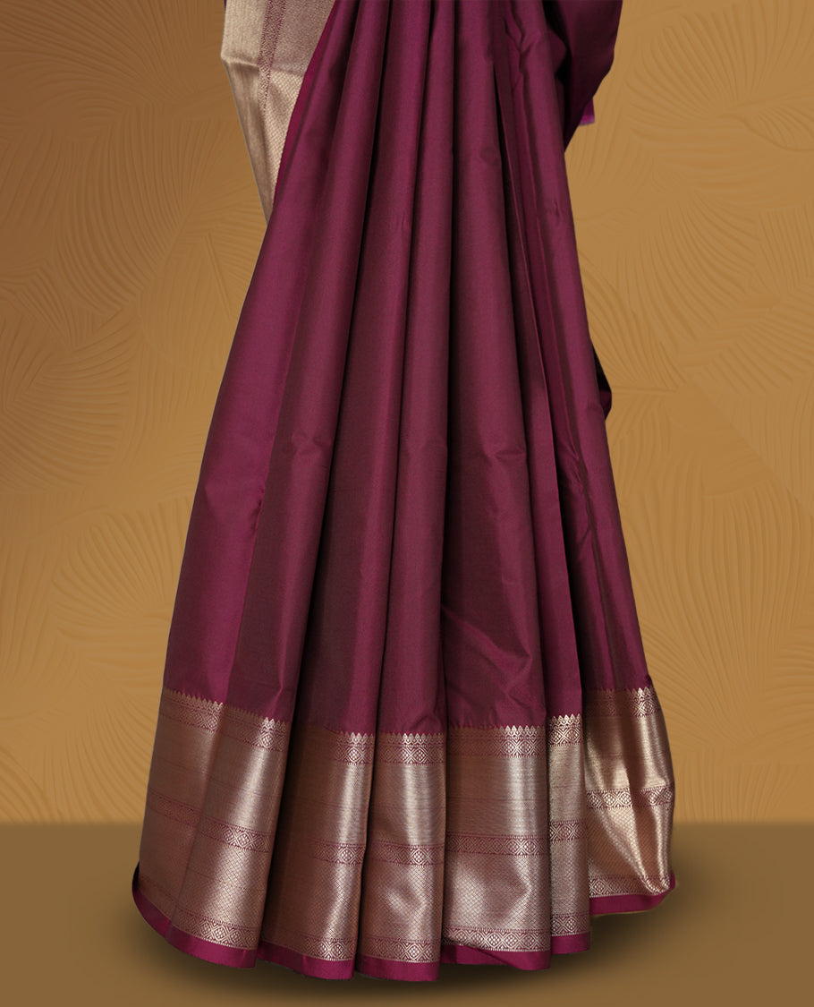 Wine colour soft silk saree beautifully adorned with silver zari buttas, paired with a rich silver zari border and pallu & Completed with a matching blouse.
