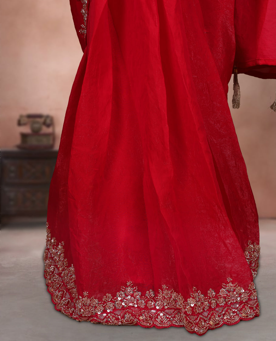 Elegant Red colour ready to wear saree adorned with rich Gold bead embroidery along the border and pallu, paired with a heavily embellished matching blouse for a grand festive look.