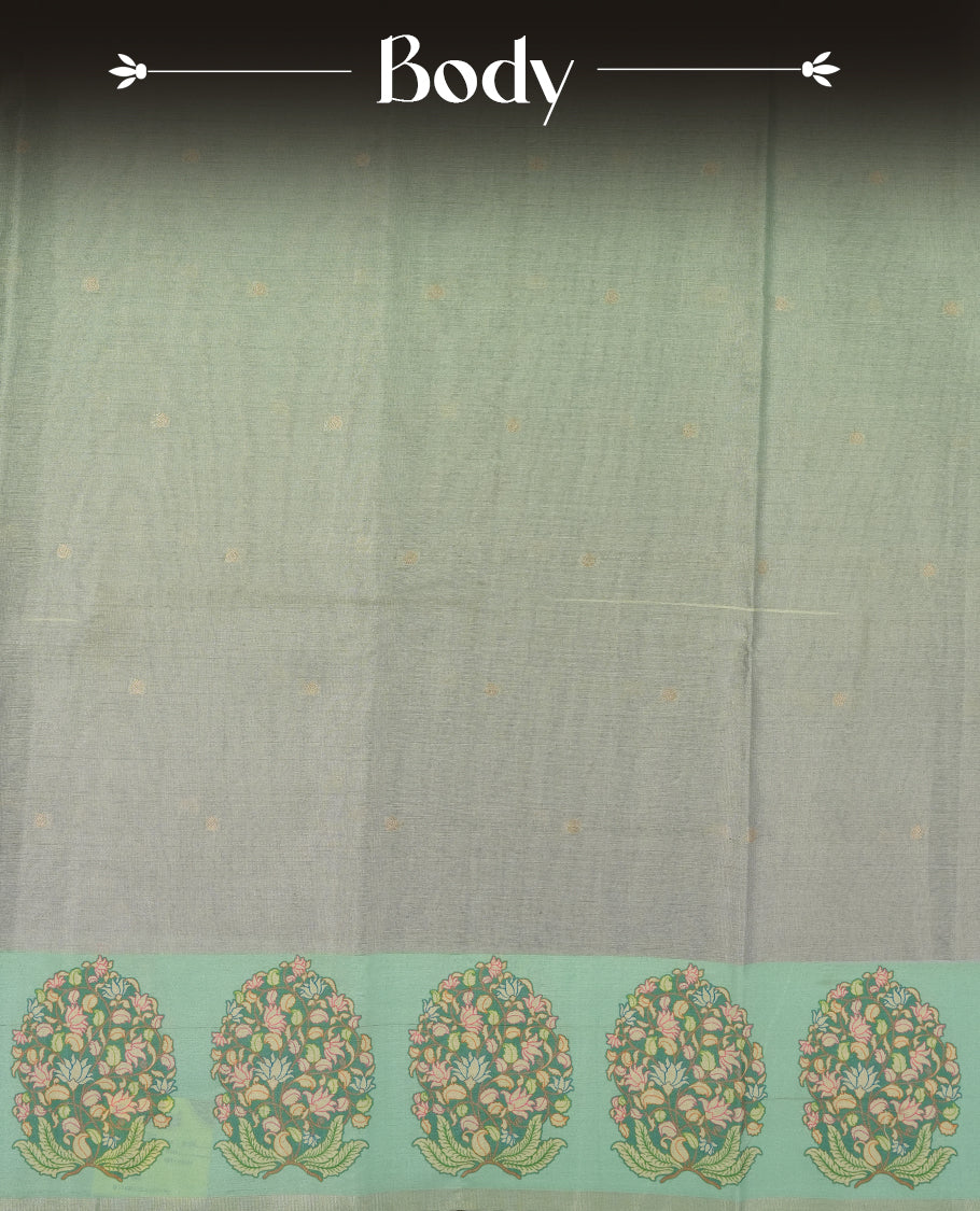 Silver colour semi tussar saree adorned with gold zari motifs across the body and Floral pattern contrast Aqua green colour on border, paired with a matching blouse.