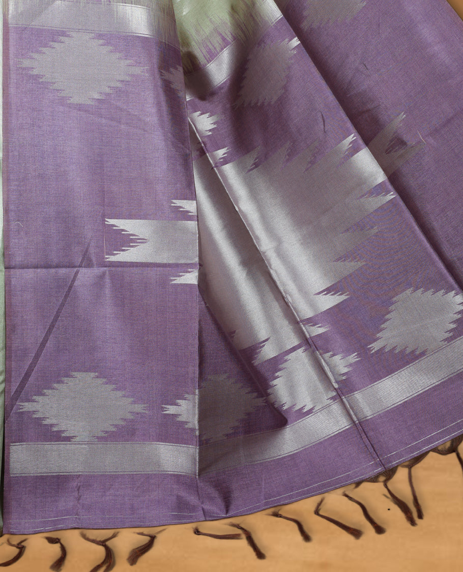 Olive and silver colour dual tone semi tussar saree featuring woven abstract geometric motifs on the body, complemented by a ikat inspired contrast Lavender purple patterned pallu, paired with a matching blouse.