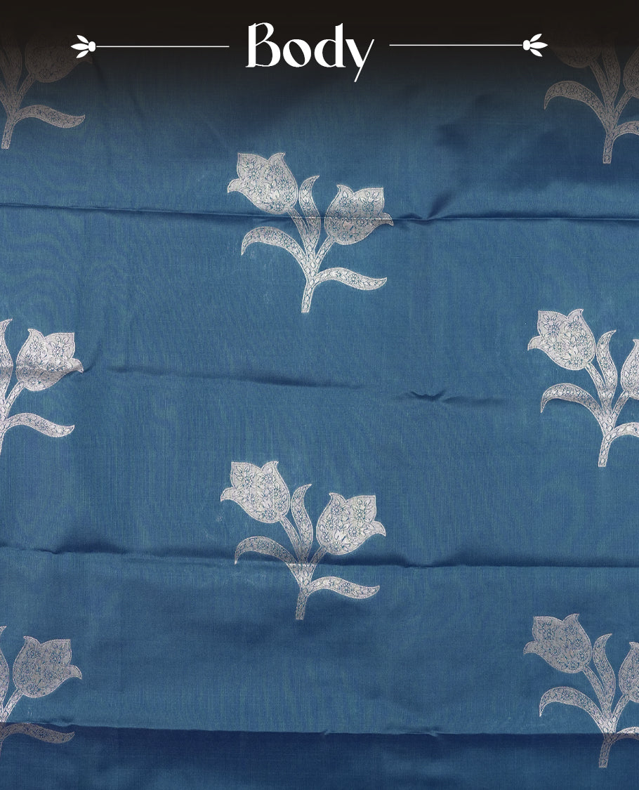 Teal Blue Semi Silk Saree with Silver Zari Floral Woven Pallu and Border, Subtle Zari Butta Motifs on the Body, Tassel Detailing, and Coordinated Blouse Piece