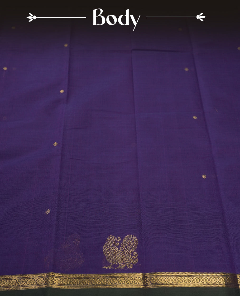 Purple colour pure Kanchi cotton saree embellished with delicate golden buttas and a graceful zari deer motif, paired with an intricately woven gold border, radiating elegance and tradition & Comes with matching blouse.