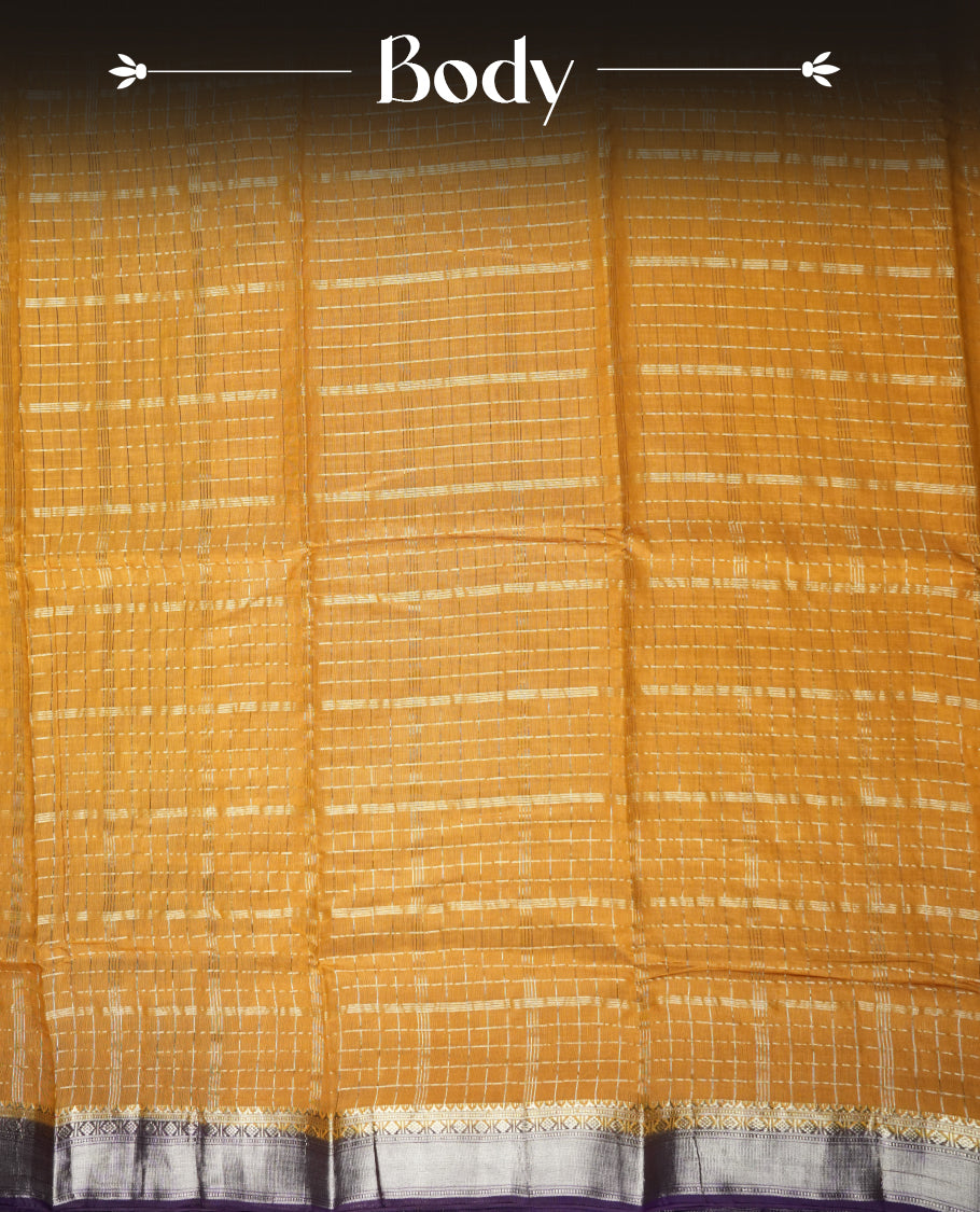 Mustard yellow colour mixed chanderi cotton saree with checkered body, deep purple pallu with rose gold zari border, and matching purple blouse.