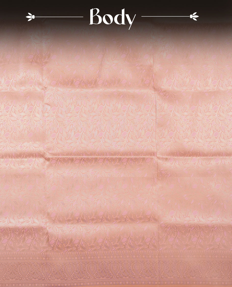 Peach colour semi soft silk saree featuring an all-over woven leaf pattern, finished with a matching pastel peach border adorned with detailed paisley and floral motifs, and a matching blouse piece.