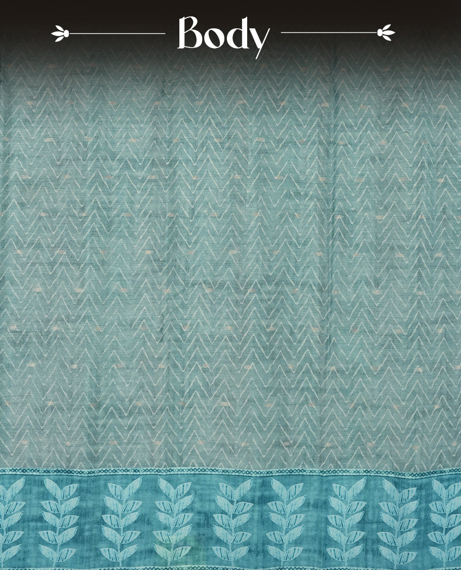Aqua blue colour semi tussar saree adorned with Cream Zigzag printed pattern across the body and Leaf pattern on contrast aqua blue colour border, paired with a matching blouse.
