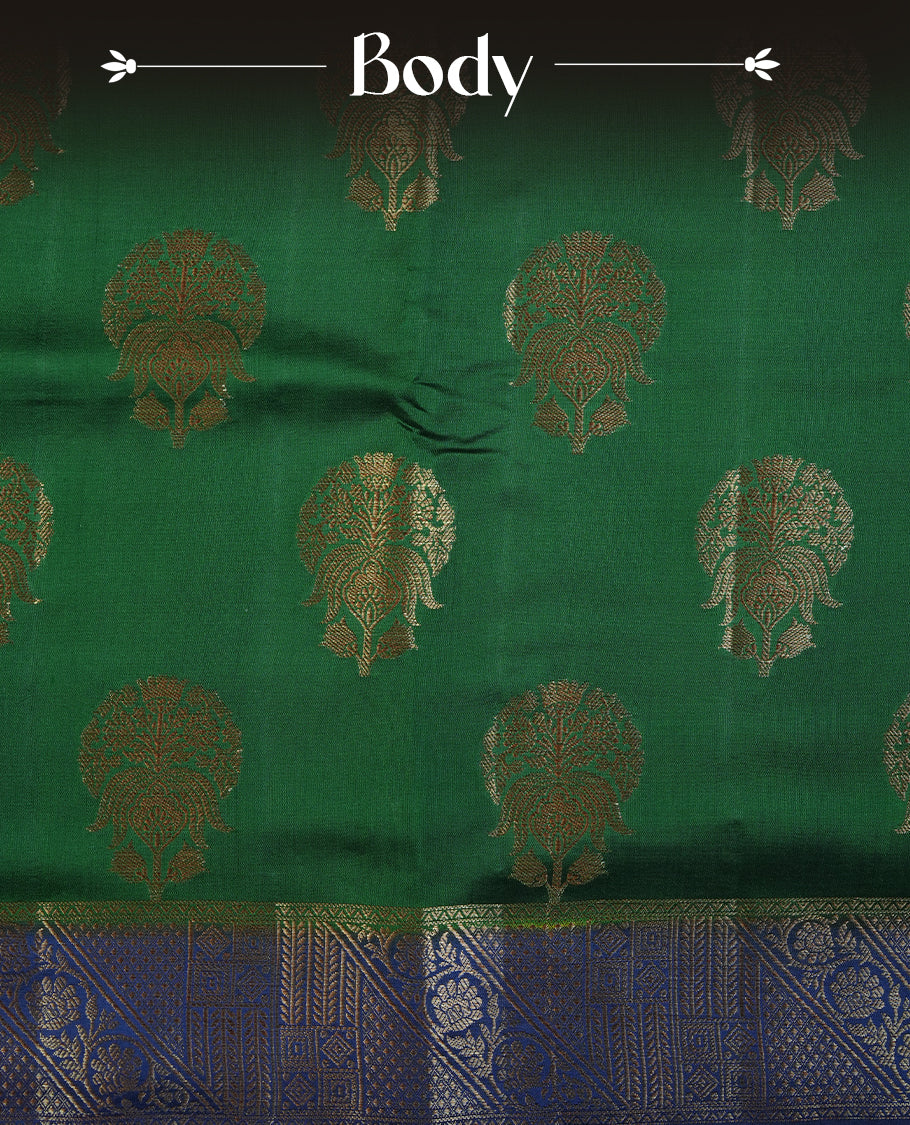 Dark green colour Pure tussar Banarasi saree featuring Gold zari motifs on body, a contrast navy blue colour gold zari border, and a matching blouse piece.