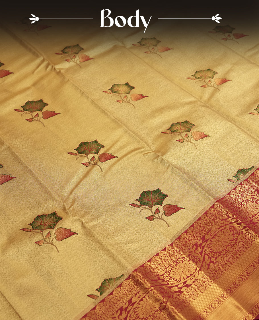 Antique golden Zari Tissue Brocade Saree features intricate green colour flower Motifs on body and a dark red colour border & pallu with traditional patterns, paired with matching blouse