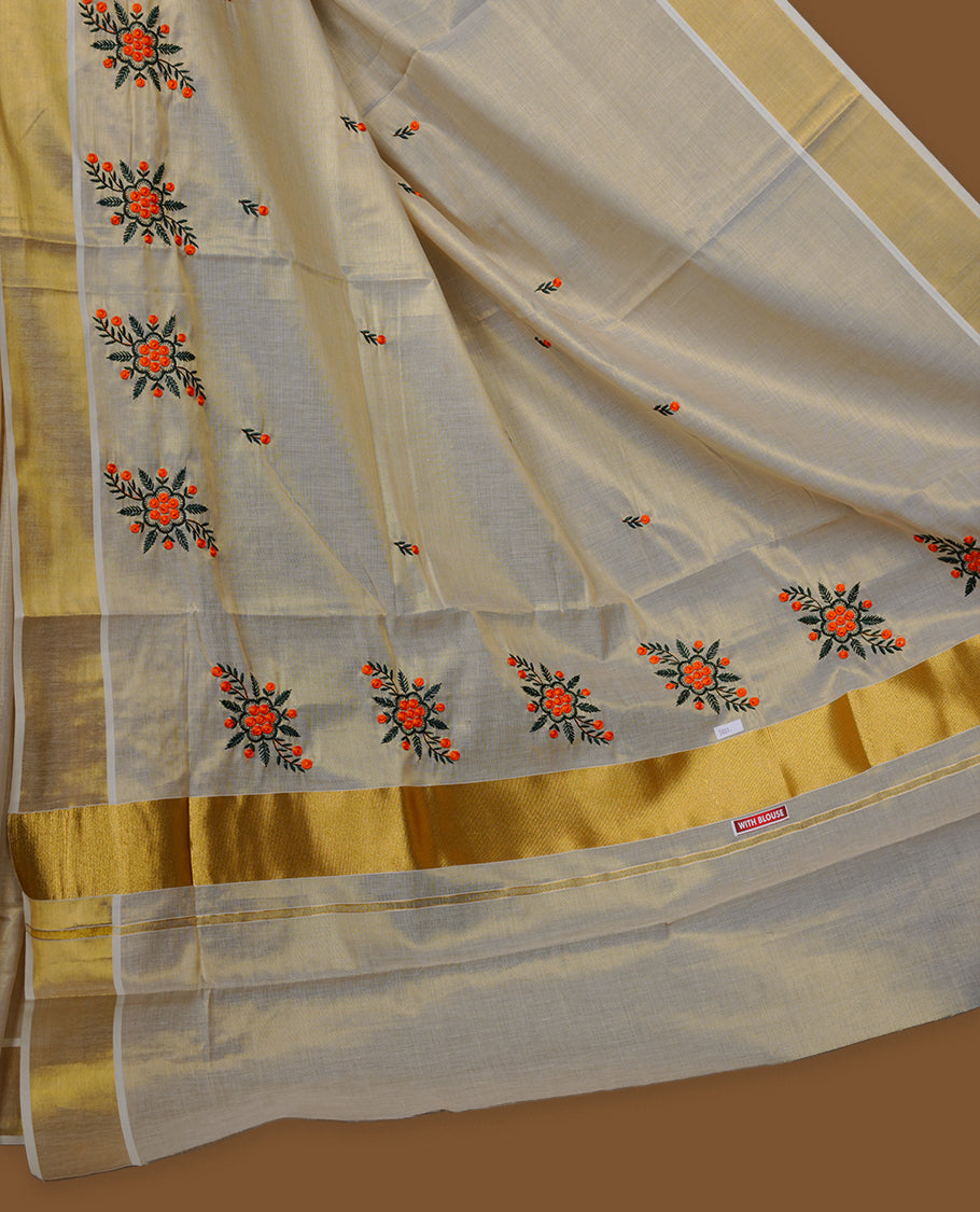 Off-white colour tissue Kerala saree with a classic gold kasavu border, highlighted by delicate orange floral embroidery across the body and pallu, and paired with a matching blouse.