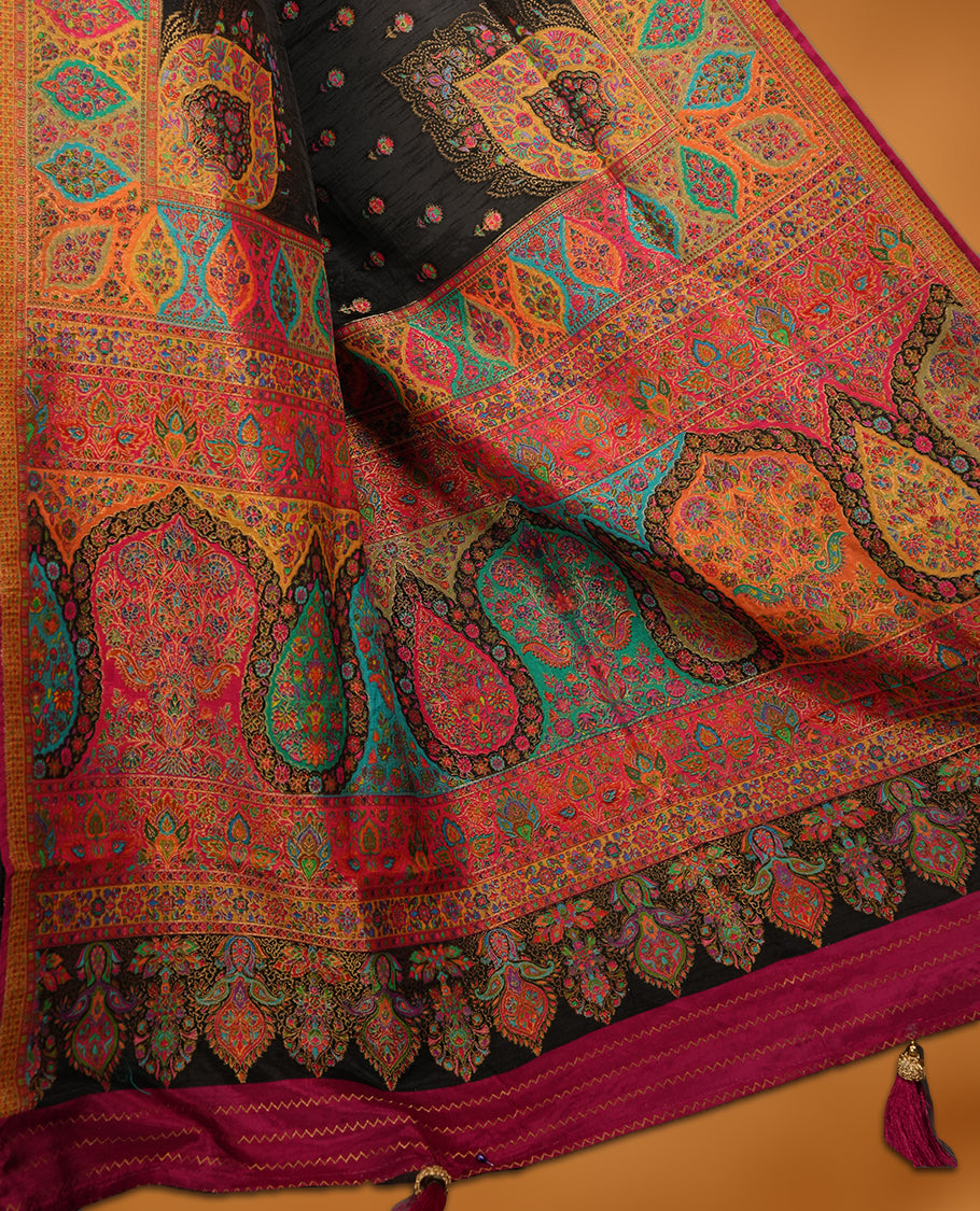 Black colour Pashmina silk saree densely woven with intricate multicolour floral motifs across the body, framed by an opulent arabesque border and grand storytelling pallu, paired with a matching woven border blouse piece