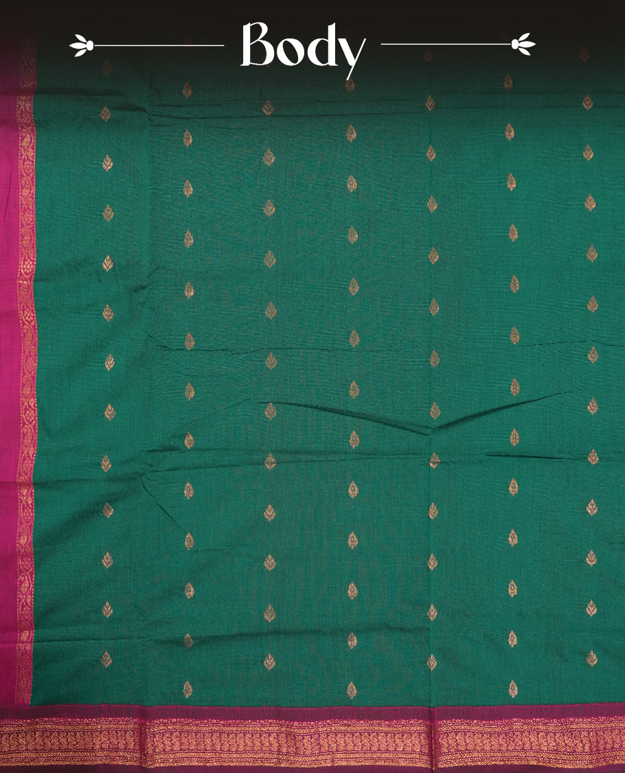 Deep Green colour Kalyani Cotton saree with golden motifs, paired with a contrasting magenta border featuring intricate zari work & Comes with a matching blouse piece.