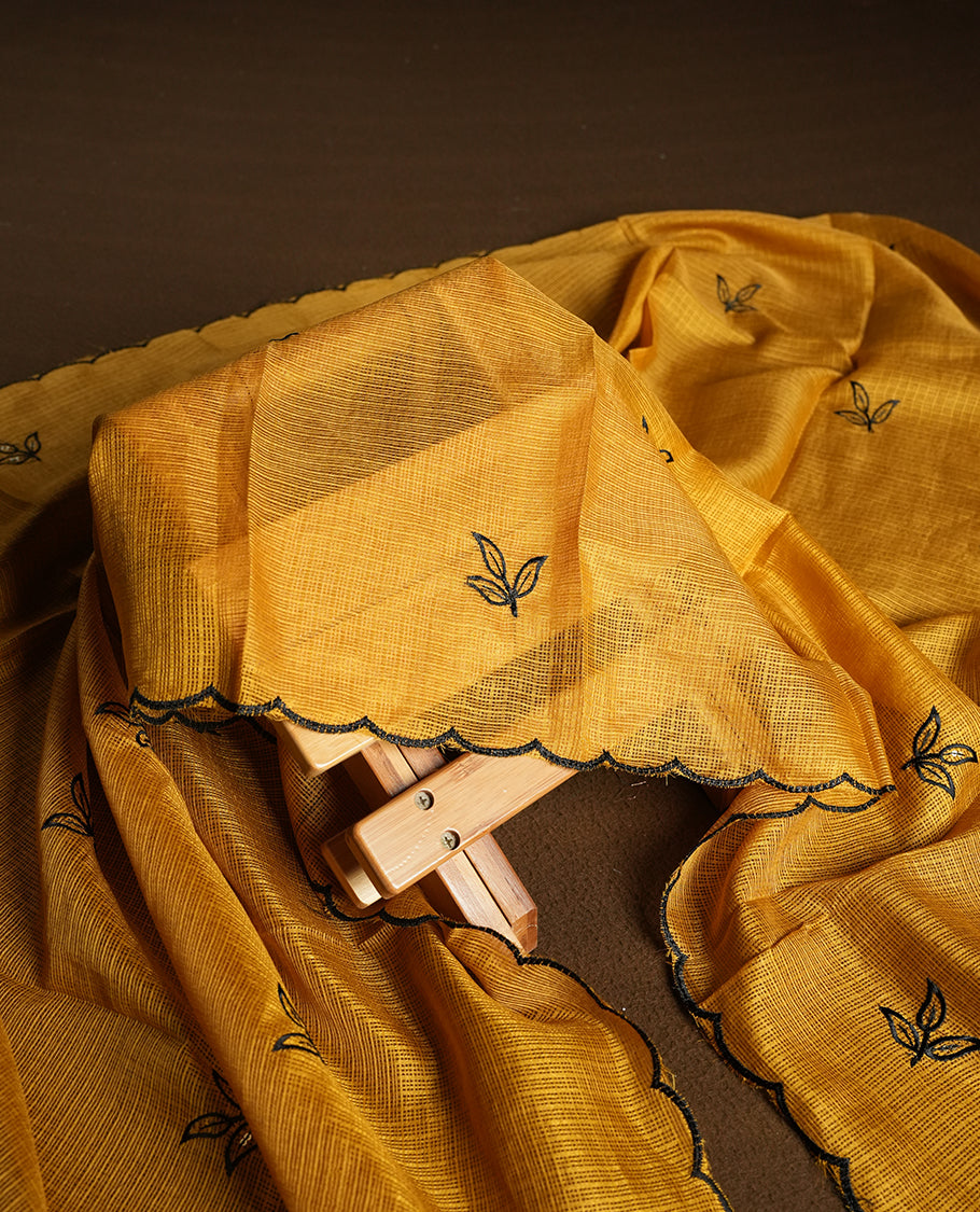 Yellow colour churidhar material featuring Black colour thread embroidery on the front panel, self colour dupatta with elegant border, and matching plain bottom
