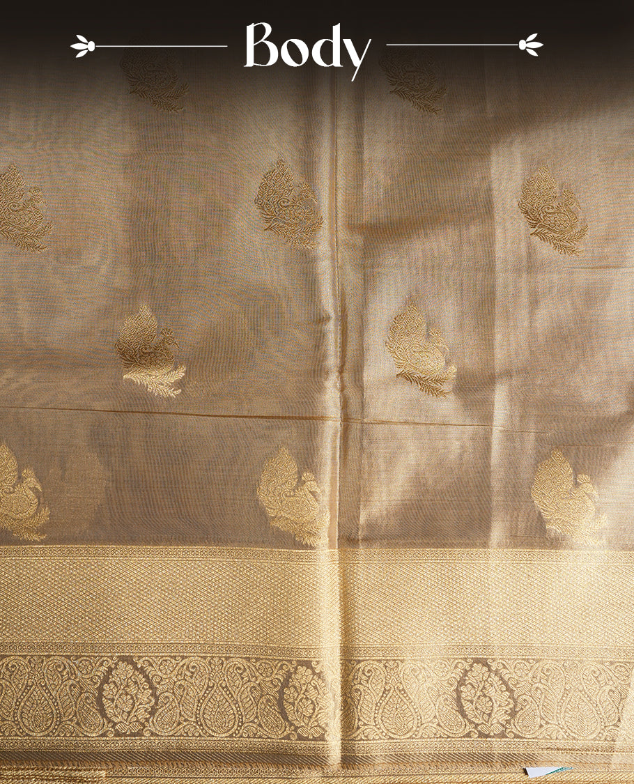 Light Gold colour tissue banaras silk saree featuring antique gold peacock zari motifs on the body with rich traditional zari border and pallu, paired with a matching blouse piece.