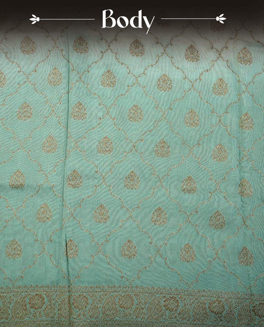 Cream colour semi tussar Banarasi saree featuring Antique zari motifs on body, paired by contrast pastel green colour border, and a matching blouse piece.