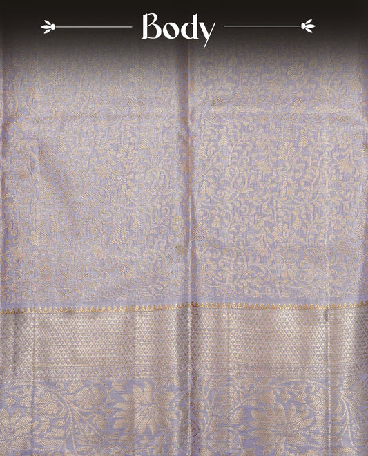 Lavender colour Semi tissue silk saree featuring gold zari kodi floral motifs on body, Self colour with traditional border, paired with matching blouse piece.