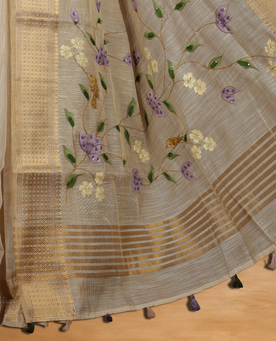 Beige colour Banarasi linen silk saree featuring hand brushed colour with Floral  & birds printed pattern on body, gold zari woven geometric design border with self colour pallu and comes with a matching blouse