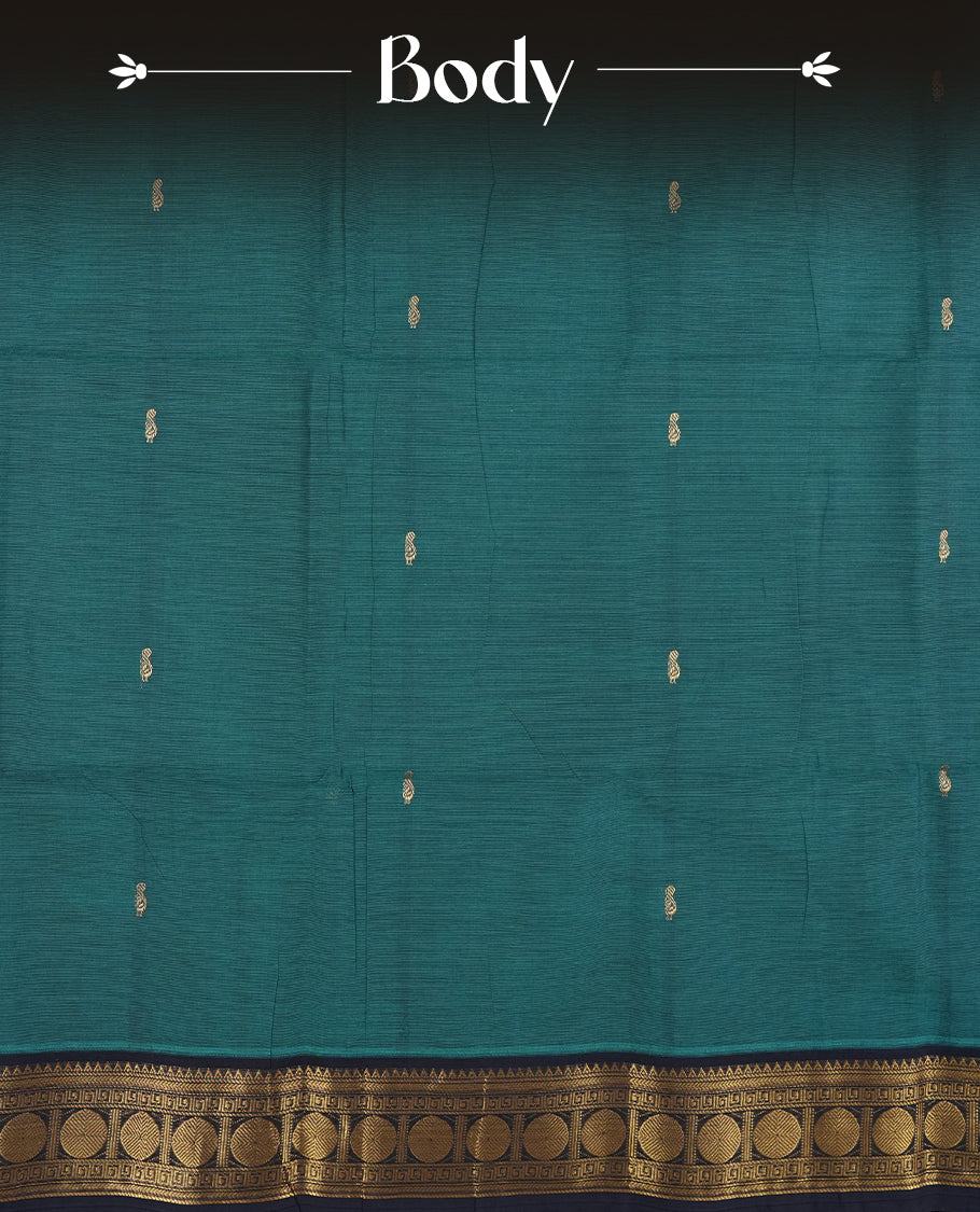 Teal blue colour Chettinad cotton saree featuring a rich contrast navy blue colour border adorned with intricate golden zari circular motifs and geometric designs & it comes with a matching blouse piece.