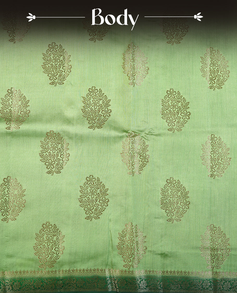 Light green colour Pure tussar Banarasi saree featuring Gold zari motifs on body, a contrast green colour gold zari border, and blouse piece.
