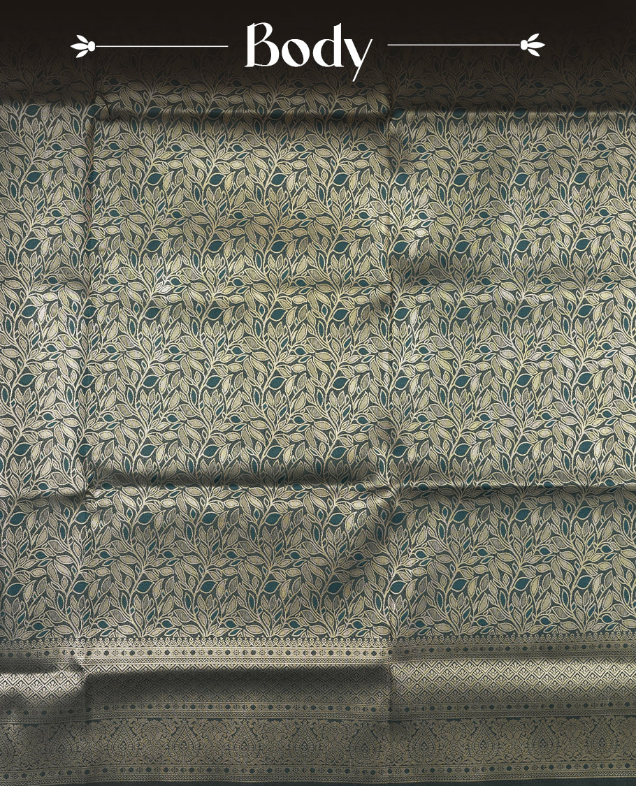 Dark Teal Green colour semi soft silk saree featuring an all-over woven leaf pattern in gold colour, finished with a matching border adorned with detailed paisley and floral motifs, and a matching blouse piece.