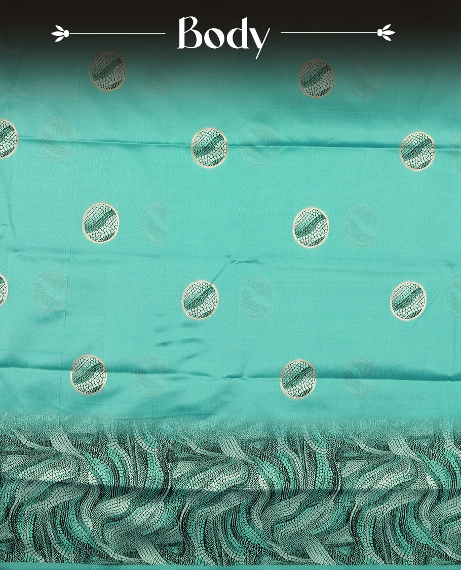 Aqua green semi silk saree featuring elegant circular motifs on the body, complemented by a striking pallu adorned with intricate wavy white and black thread patterns with golden border, and paired with a matching blouse