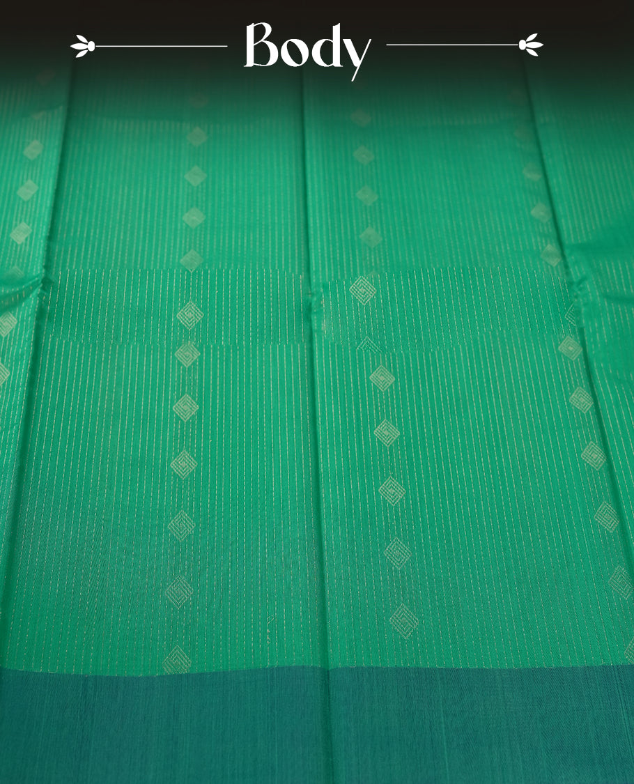 Aqua Green colour pure handloom cotton saree featuring fine golden stripes with delicate motifs, paired with a rich zari blue border for a traditional yet elegant look, perfect for graceful occasions & Comes with matching blouse.